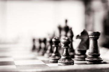 Black and white chess pieces on a chessboard