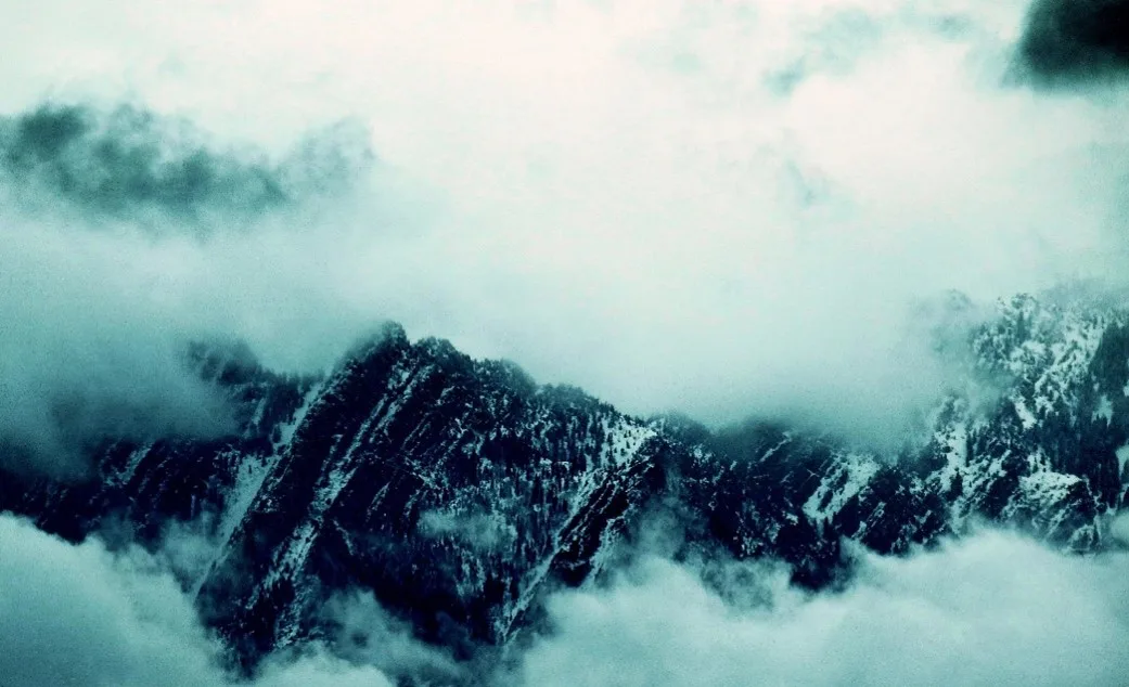 Mountain peaks breaking through low clouds